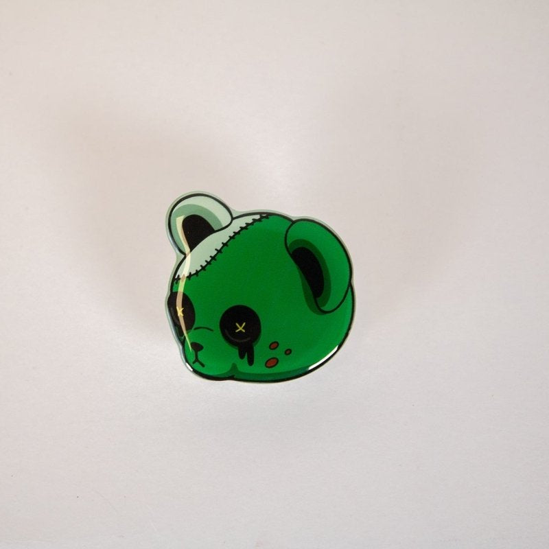 Green horror buttoneyes character with a neutral expression on a light gray background