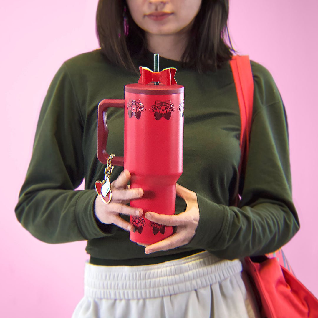 girl holding a cherry colored tumbler with cherry design on top and bottom