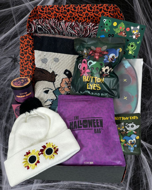 spider webs in background with a halloween mystery box showcasing items inside