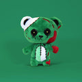 green background with zombie teddy bear named Buttoneyes
