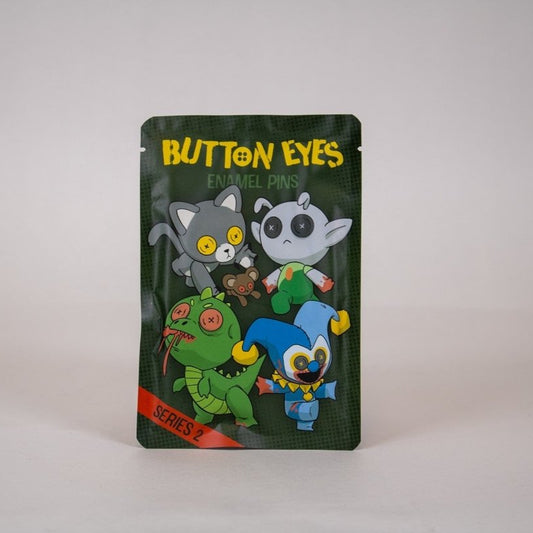 Packaged enamel pin blind bag with horror buttoneyes characters on a white background