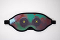 Colorful sleep mask with abstract bloody buttoneyes design on a white background