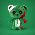 Green plush toy with zombie design on a green background