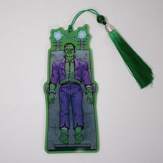 Bookmark with green tassel featuring a Frankenstein character in a suit on a white background