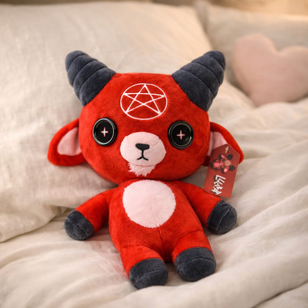 red devil goat stuffed animal laying down on bed named "Lucibaa"