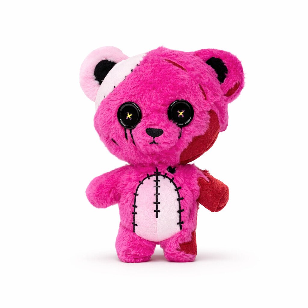 Pink plush toy with black eyes and a white bandage on a white background
