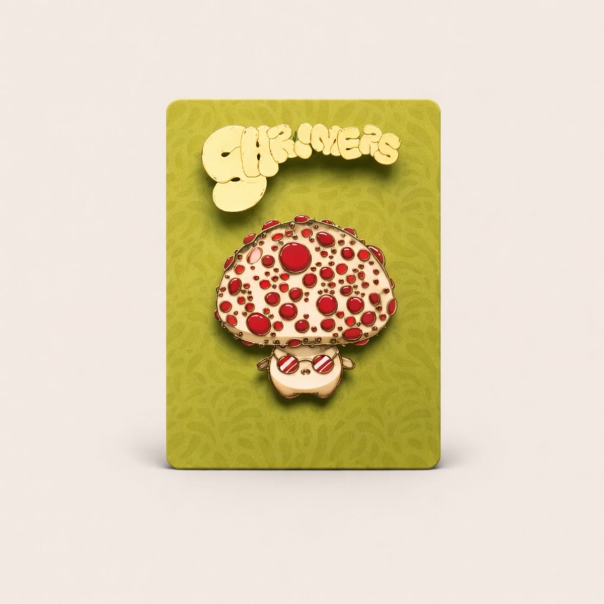 Mushroom-shaped pin with red spots on a green card with 'Shroomers' branding.