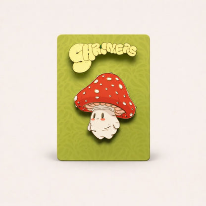 Pin with a mushroom design on a green card with 'Shroomers' branding.
