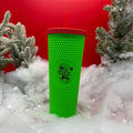 Red lid neon green studded tumbler with creepy elf
