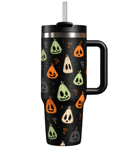 A black handled travel tumbler with a stainless steel straw, decorated with a repeating pattern of jack-o'-lanterns and ghosts in orange, green, beige, and gray on a white background.