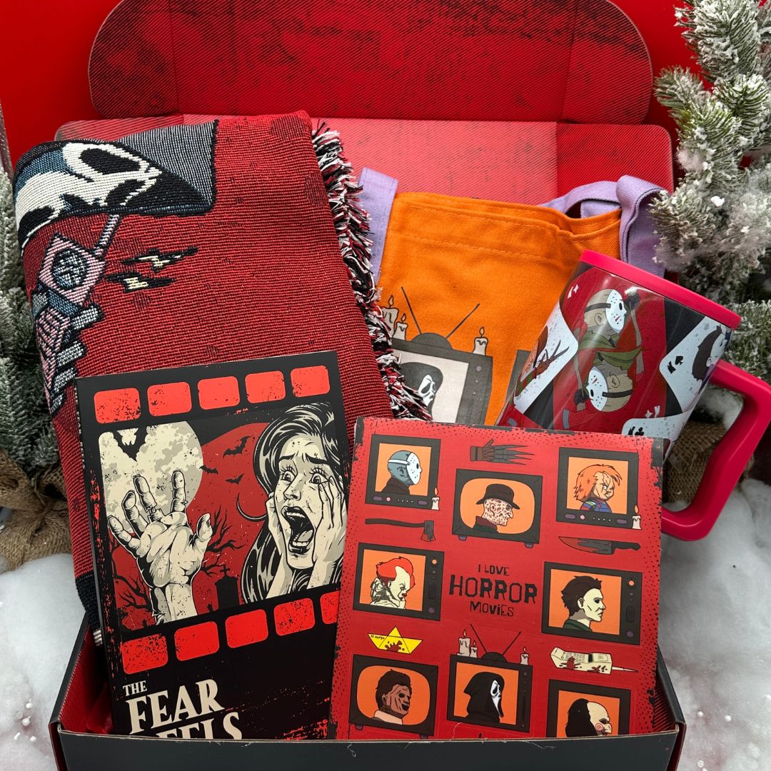Collection of horror-themed products including a blanket, books, and a bag in a box with Christmas decorations.