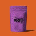 orange background with purple bag with black text "Halloween Bag" on bag.