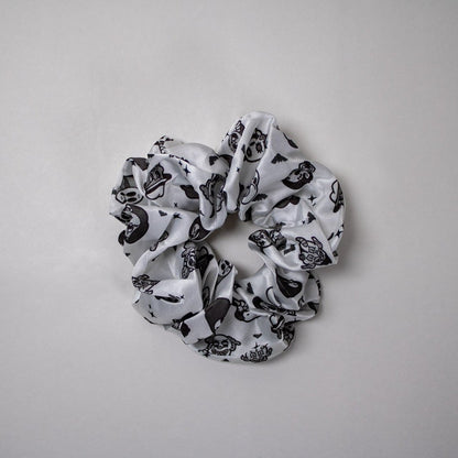 Black and white patterned  horror scrunchie on a gray background